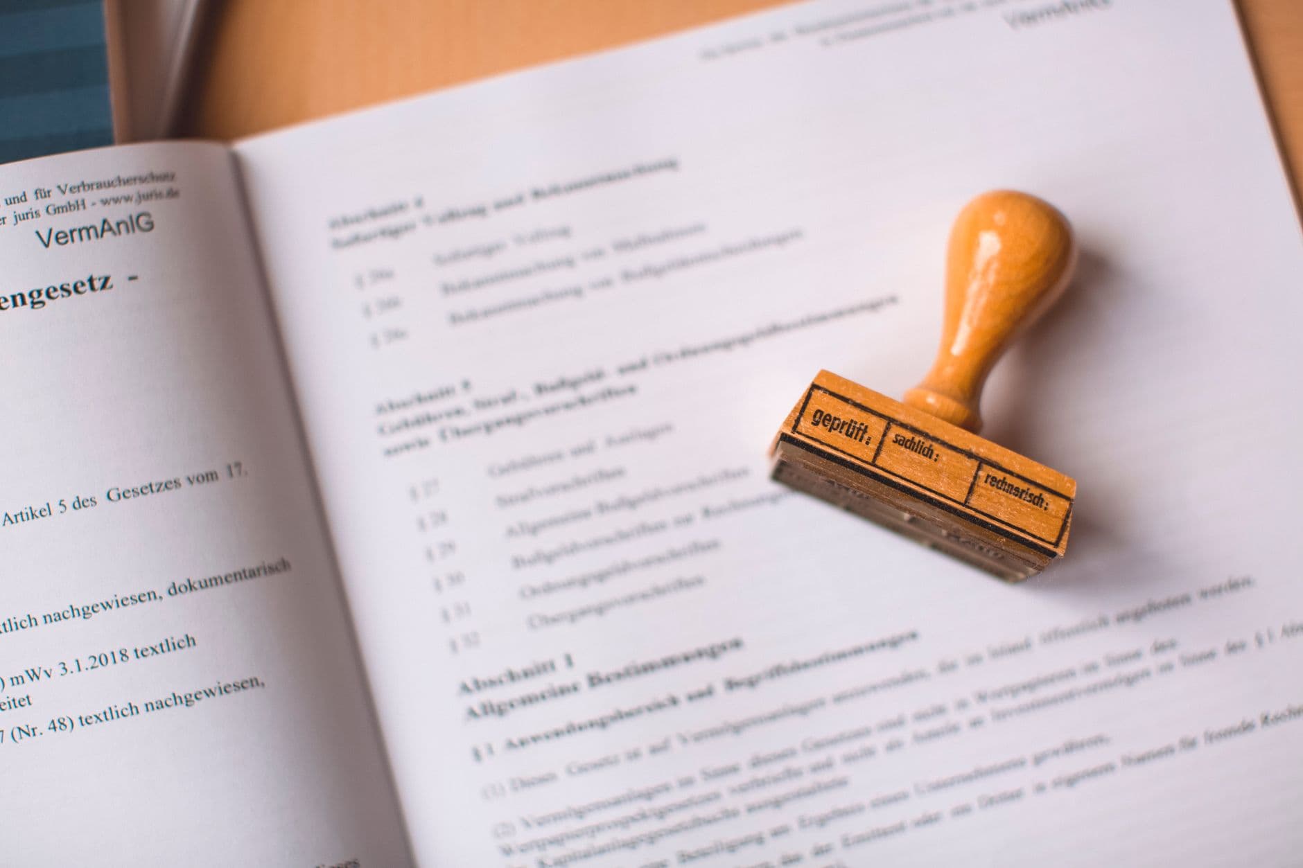 Close-up of a legal document with a wooden stamp placed on top.