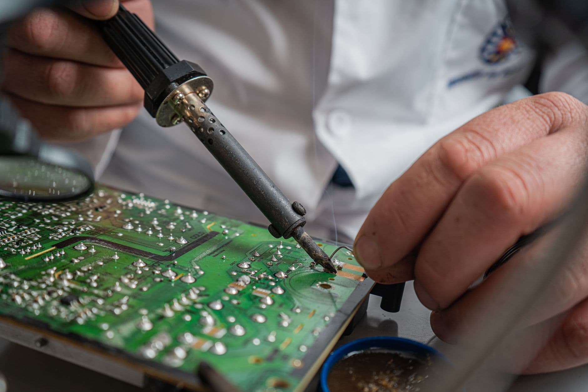 A technician soldering a circuit board.