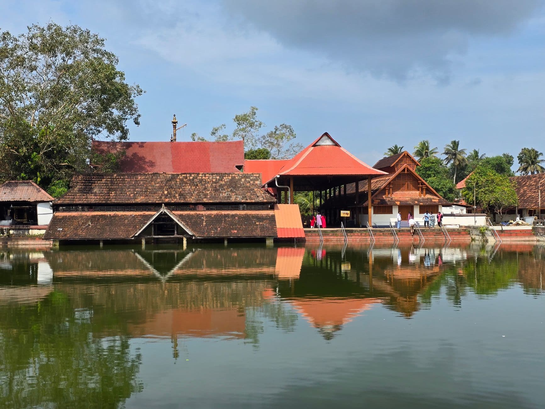 Tranquil view of Padmanabhaswamy Temple reflecting in water in Kerala, India.